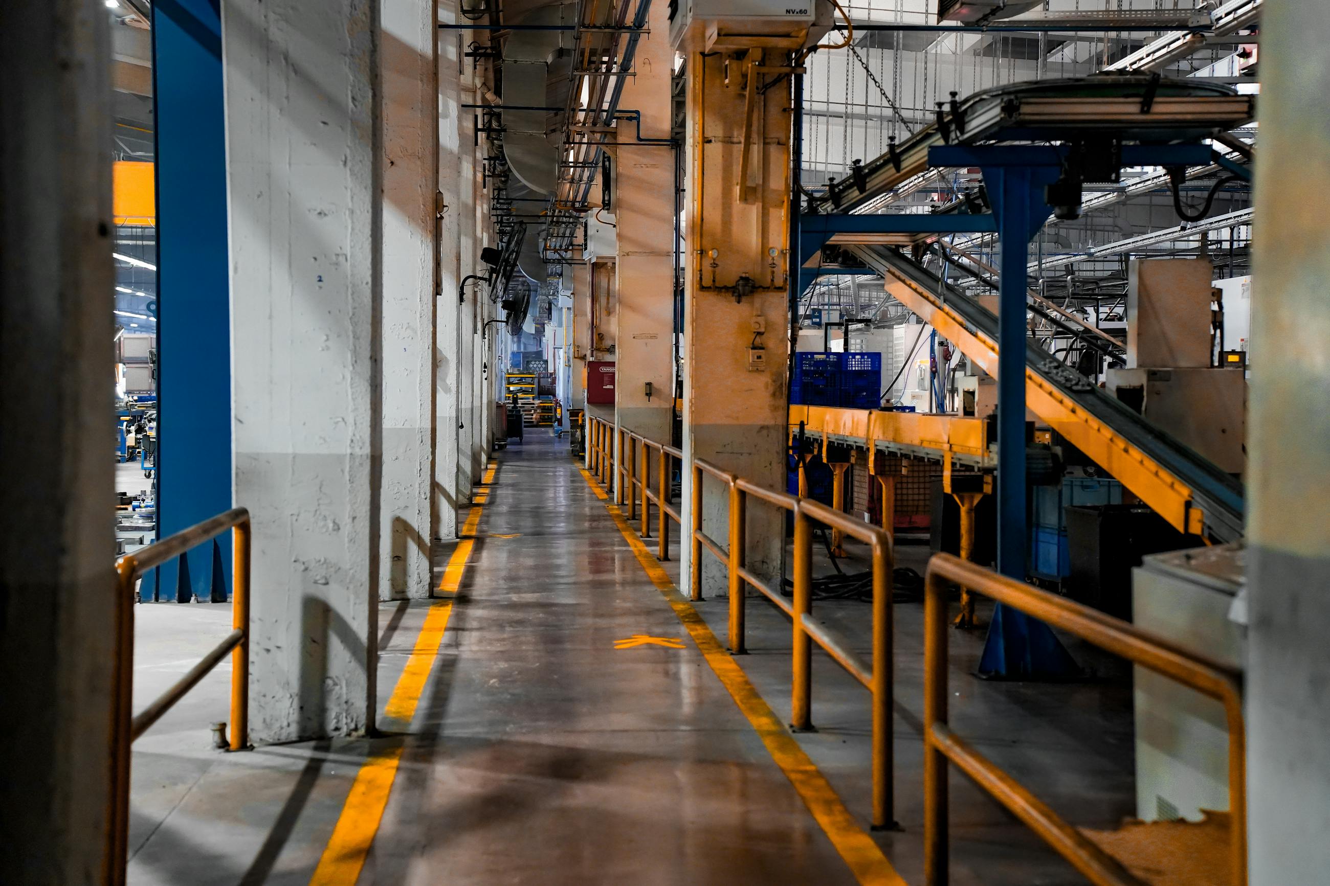 Industrial factory production aisle with equipment and safety markings